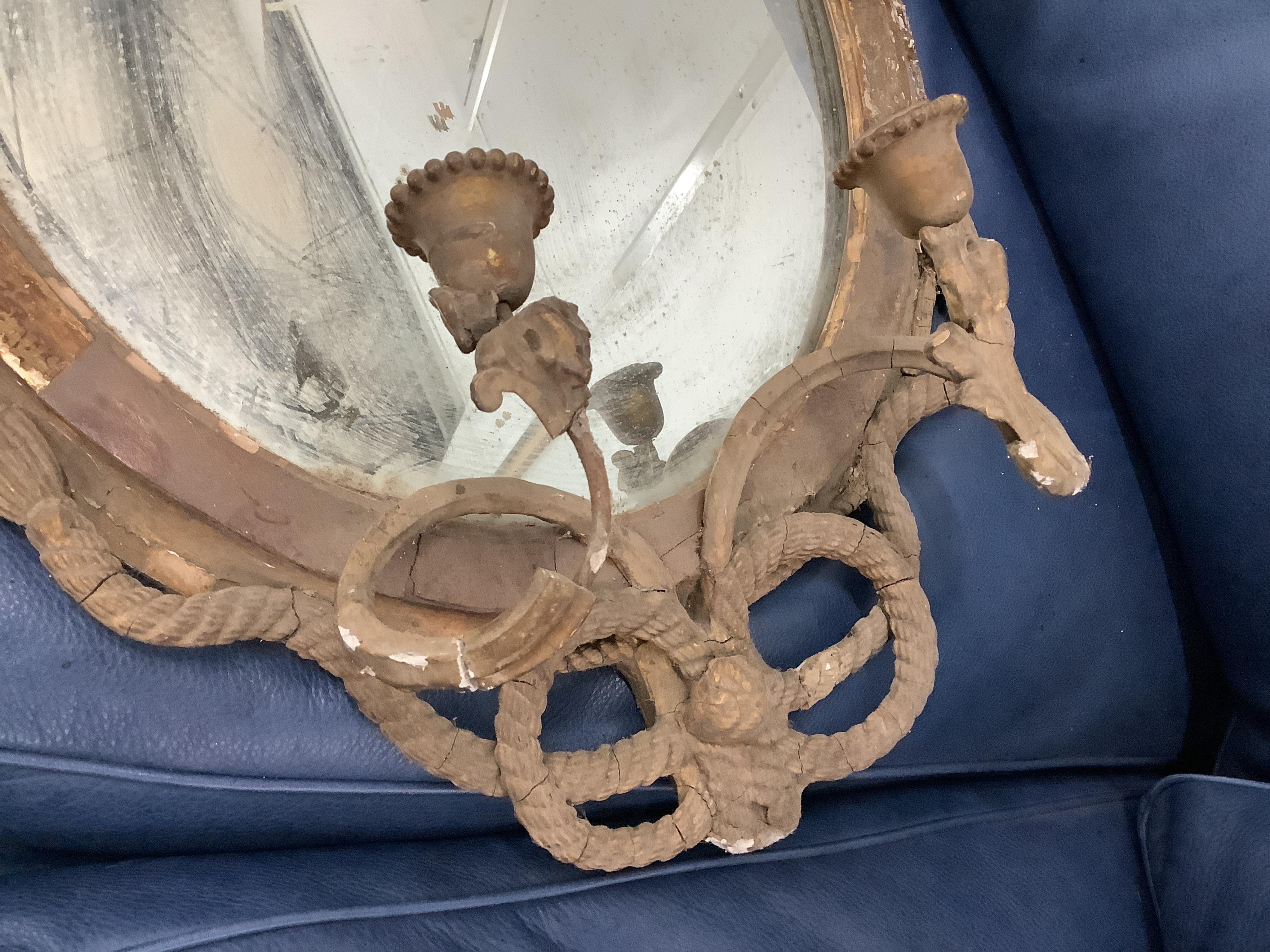 A Regency circular giltwood convex wall mirror with lion pediment, diameter 65cm a Regency convex mirror frame and Victorian girandole. Condition - poor